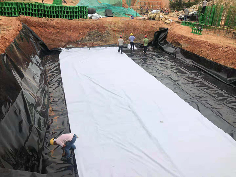 Lay the geomembrane on the first layer of geotextile and Put the second layer of geotextile on the geomembrane